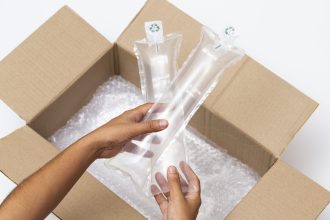 hands-holding-airbag-cushion-protecting-goods-from-delivery-opened-cardboard-box hands-holding-airbag-cushion-protecting-goods-from-delivery-opened-cardboard-box